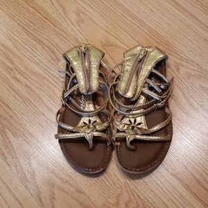 Gold American Eagle gladiator sandals
